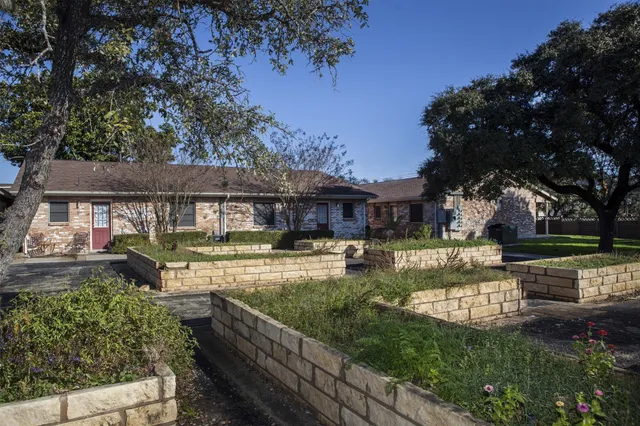 a view of house with swimming pool and a yard