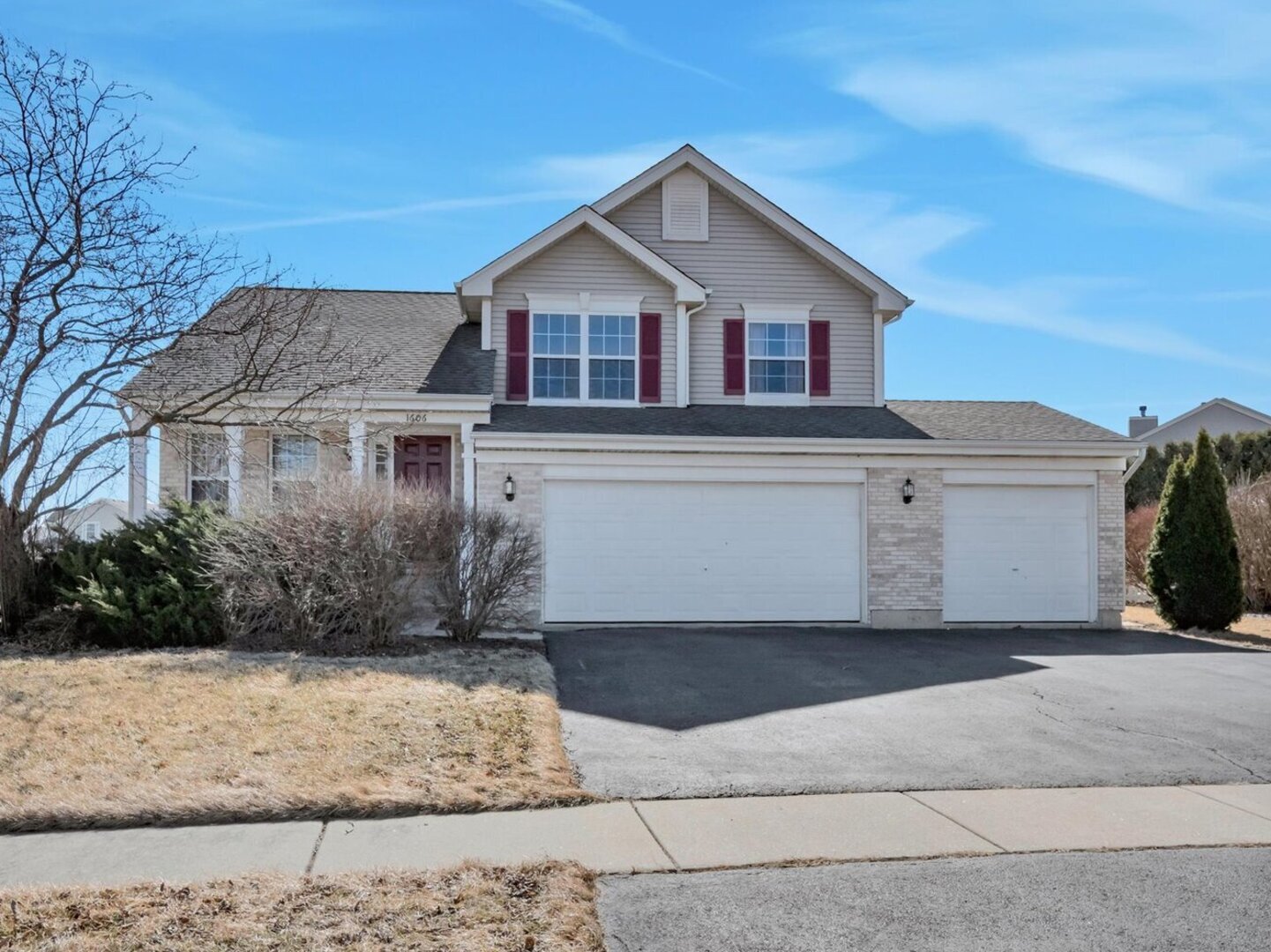 a view of a white house next to a yard