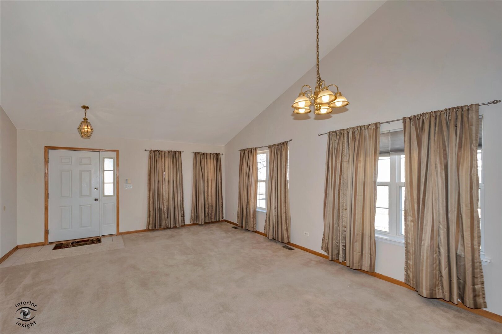 1606 Donegal Drive Minooka, IL 60447 - Photo 3 of 25 a view of a hallway with windows and chandelier