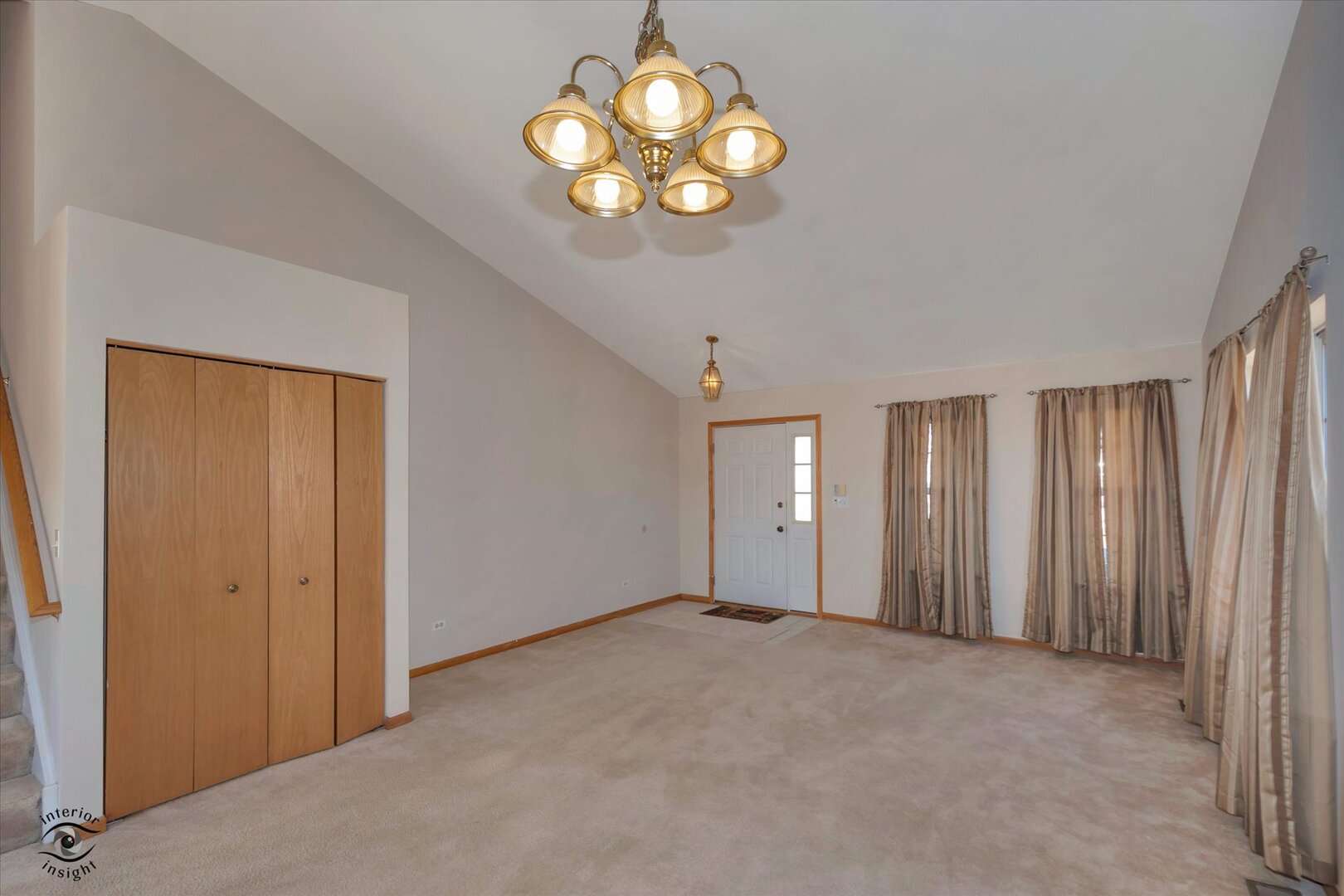 1606 Donegal Drive Minooka, IL 60447 - Photo 5 of 25 an empty room with chandelier fan and windows