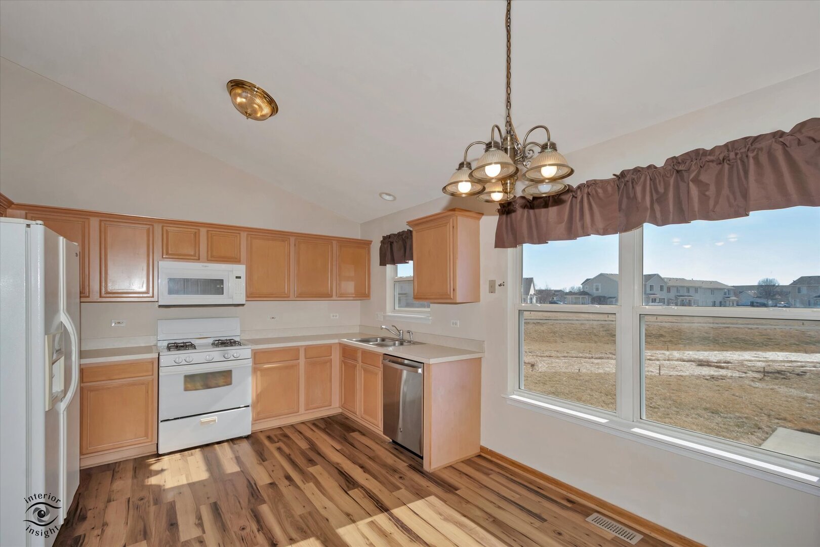 1606 Donegal Drive Minooka, IL 60447 - Photo 7 of 25 a kitchen that has a lot of cabinets and wooden floor