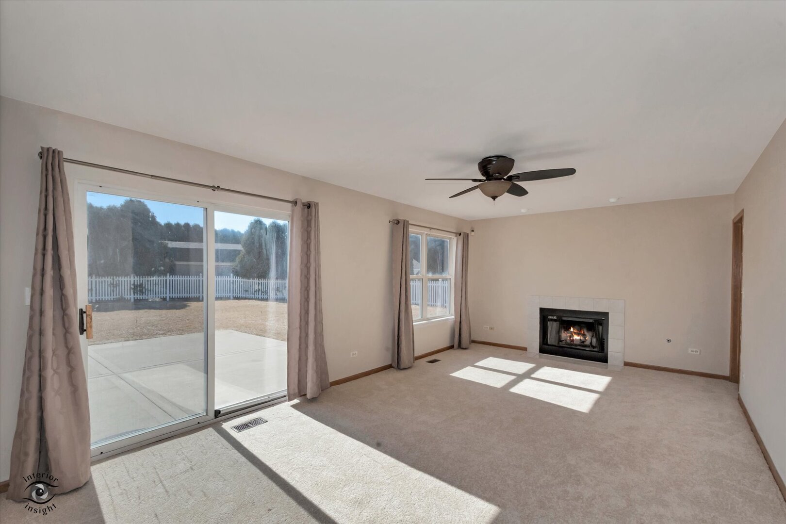 1606 Donegal Drive Minooka, IL 60447 - Photo 9 of 25 a living room with a fireplace and a ceiling fan