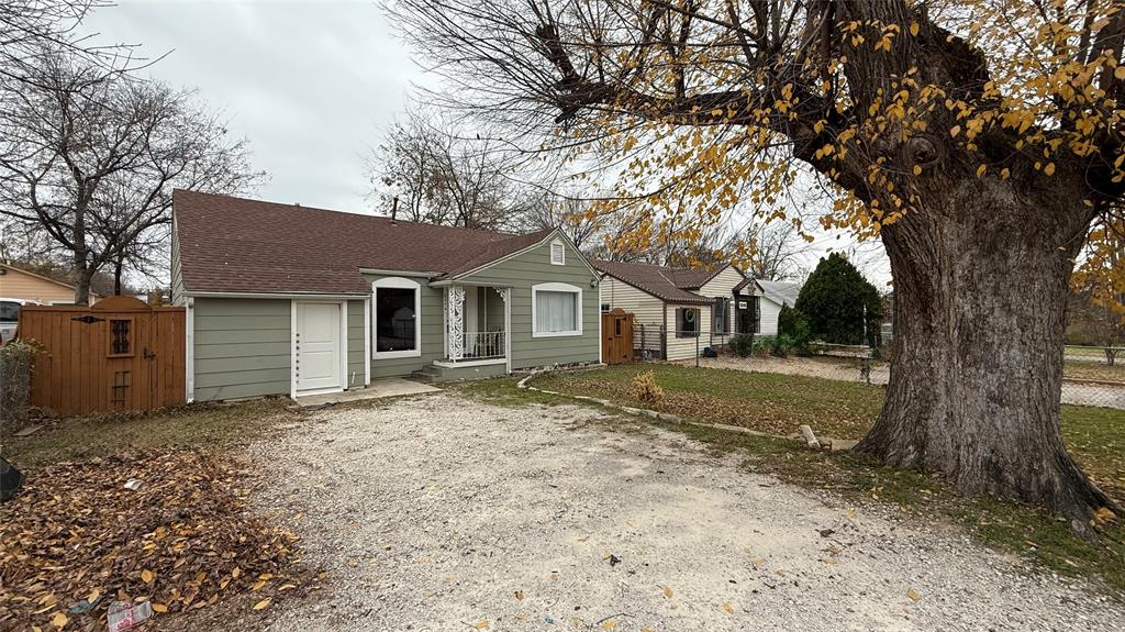 2246 Anson Road Dallas, TX 75235 - Photo 2 of 20 Light green exterior with white trim and a brown shingle roof