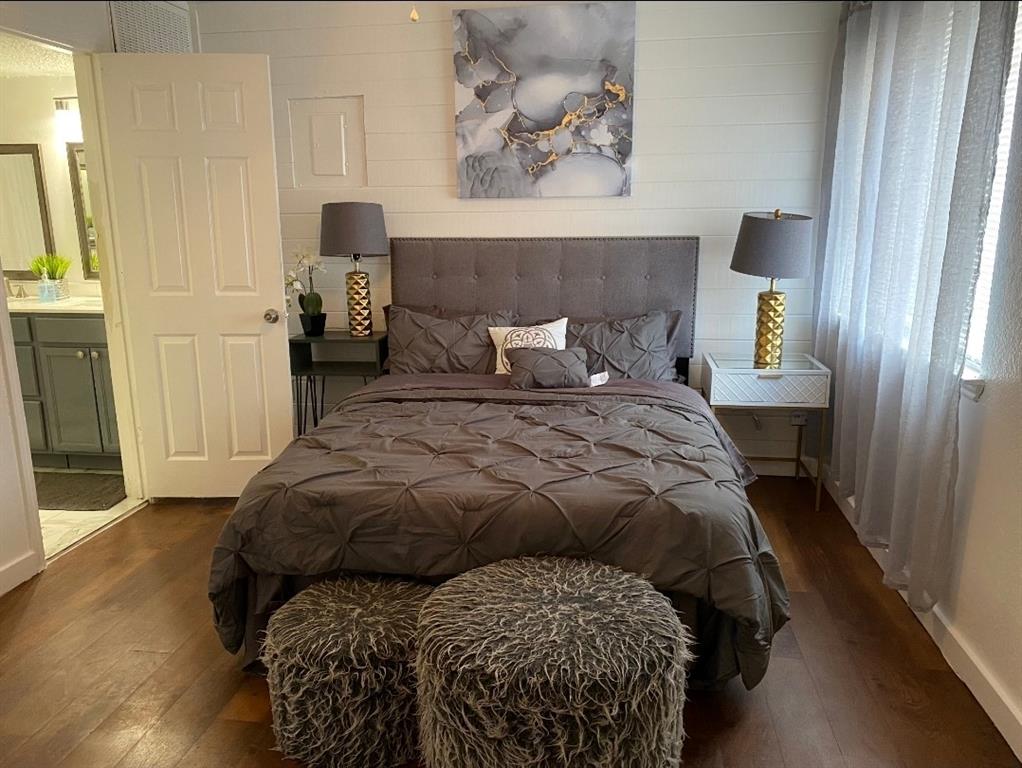 9827 Walnut Street, Unit 112 Dallas, TX 75243 - Photo 2 of 3 a bedroom with a bed and a painting on the wall