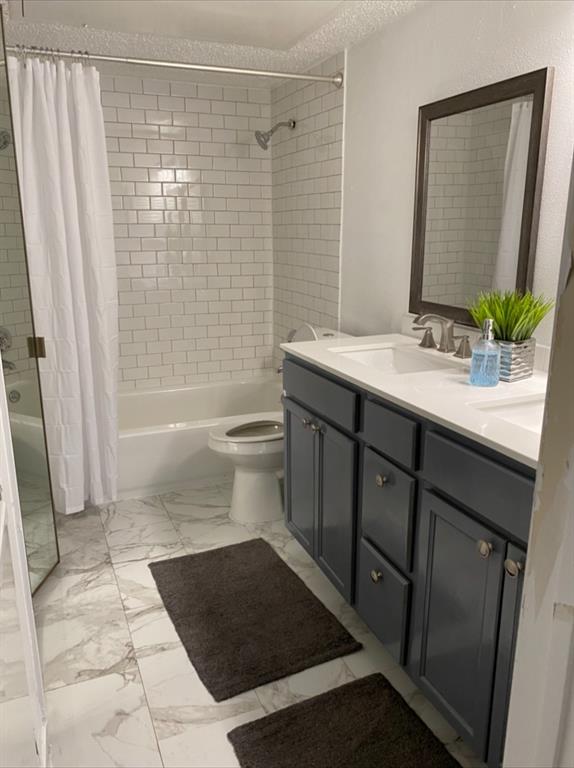 9827 Walnut Street, Unit 112 Dallas, TX 75243 - Photo 3 of 3 a bathroom with a sink a toilet and shower
