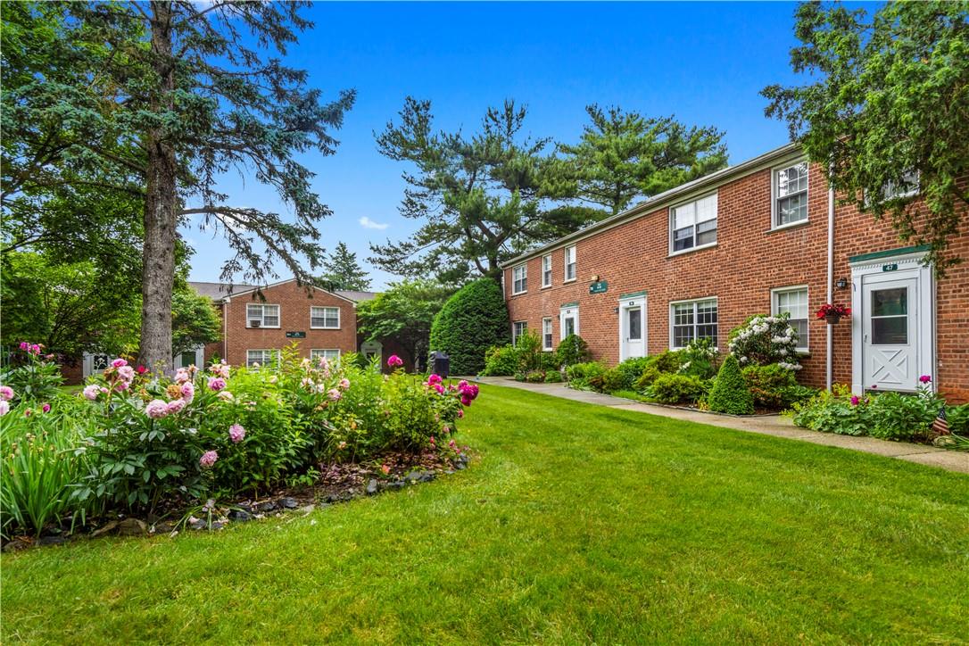 178 Pinewood Road, Unit 49 Hartsdale, NY 10530 - Photo 1 of 1 a front view of a house with garden