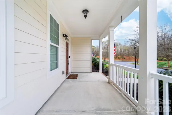 a view of a porch with wooden floor and stairs