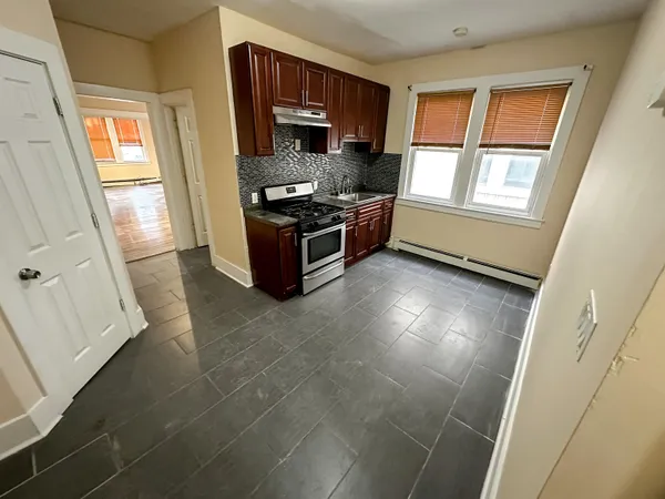 a kitchen with stainless steel appliances a refrigerator and a stove top oven