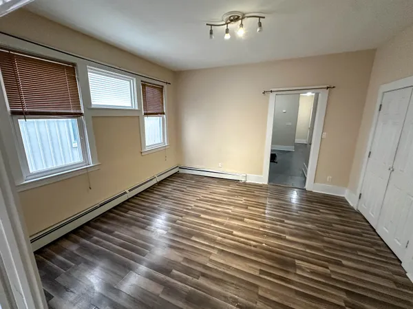 wooden floor in an empty room with a window