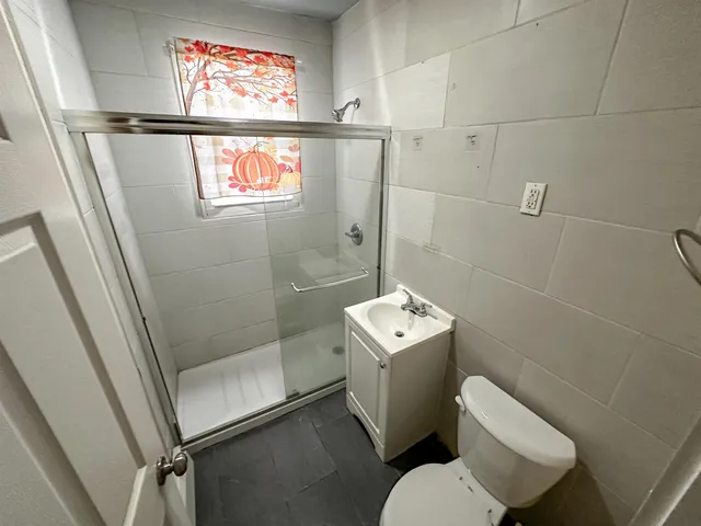 a bathroom with a toilet and a shower