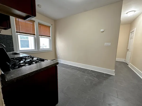 a kitchen with a stove and a window