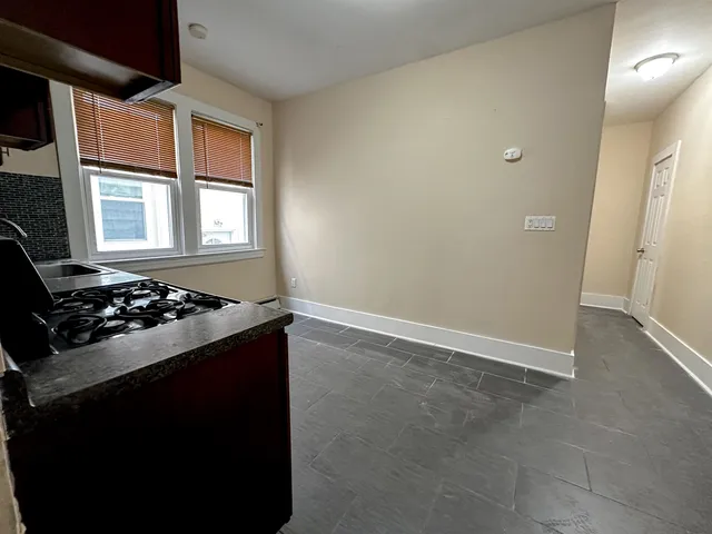 a kitchen with a stove and a window