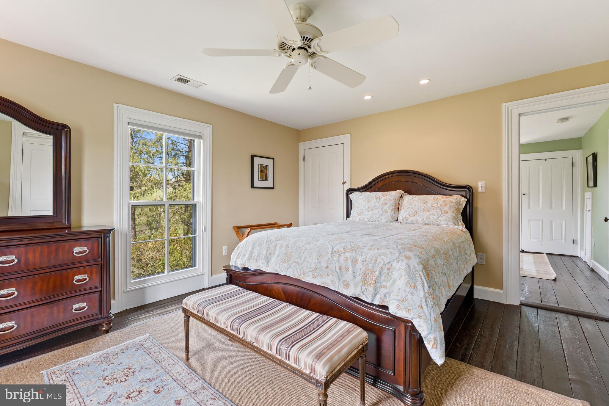 3459 Carrington Road Delaplane, VA 20144 - Photo 33 of 106 a bedroom with a bed a dresser and a window