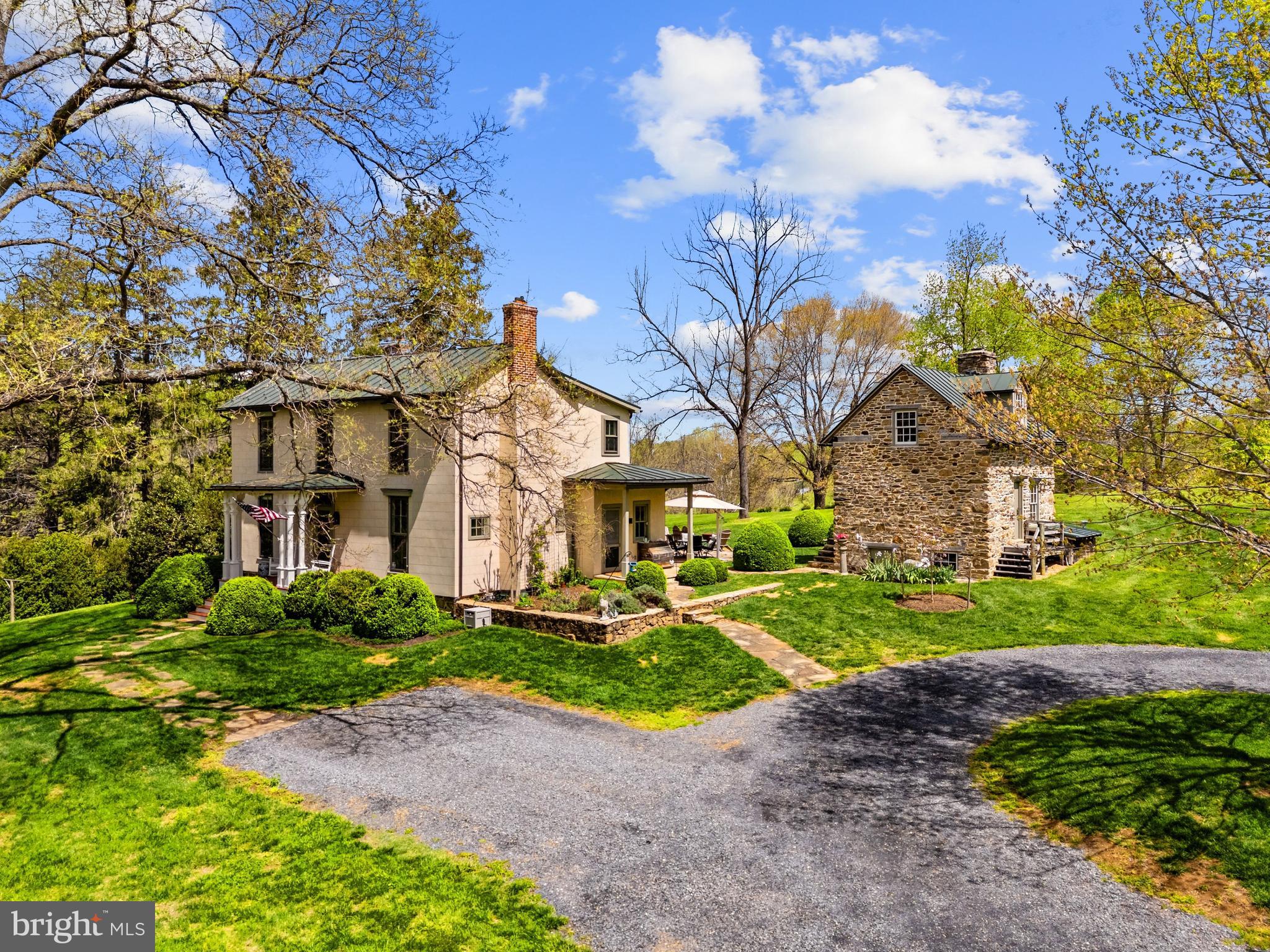 3459 Carrington Road Delaplane, VA 20144 - Photo 96 of 106 a view of a white house next to a yard with big trees