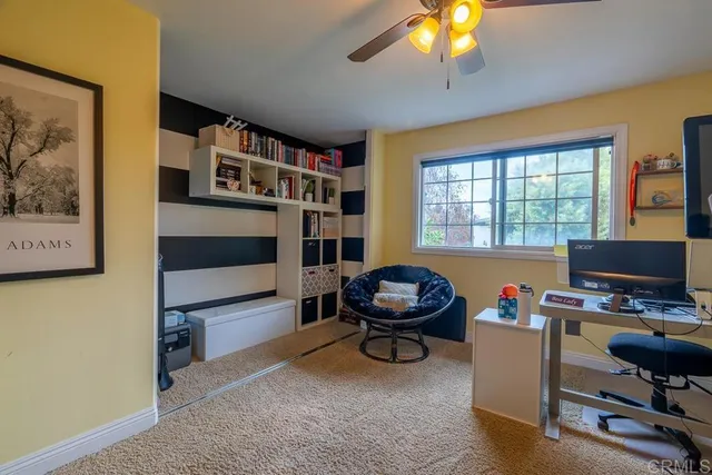 a living room with furniture a window and gym equipment
