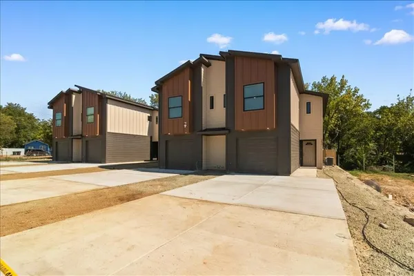 a kitchen with stainless steel appliances a refrigerator a sink dishwasher with a stove and wooden floor