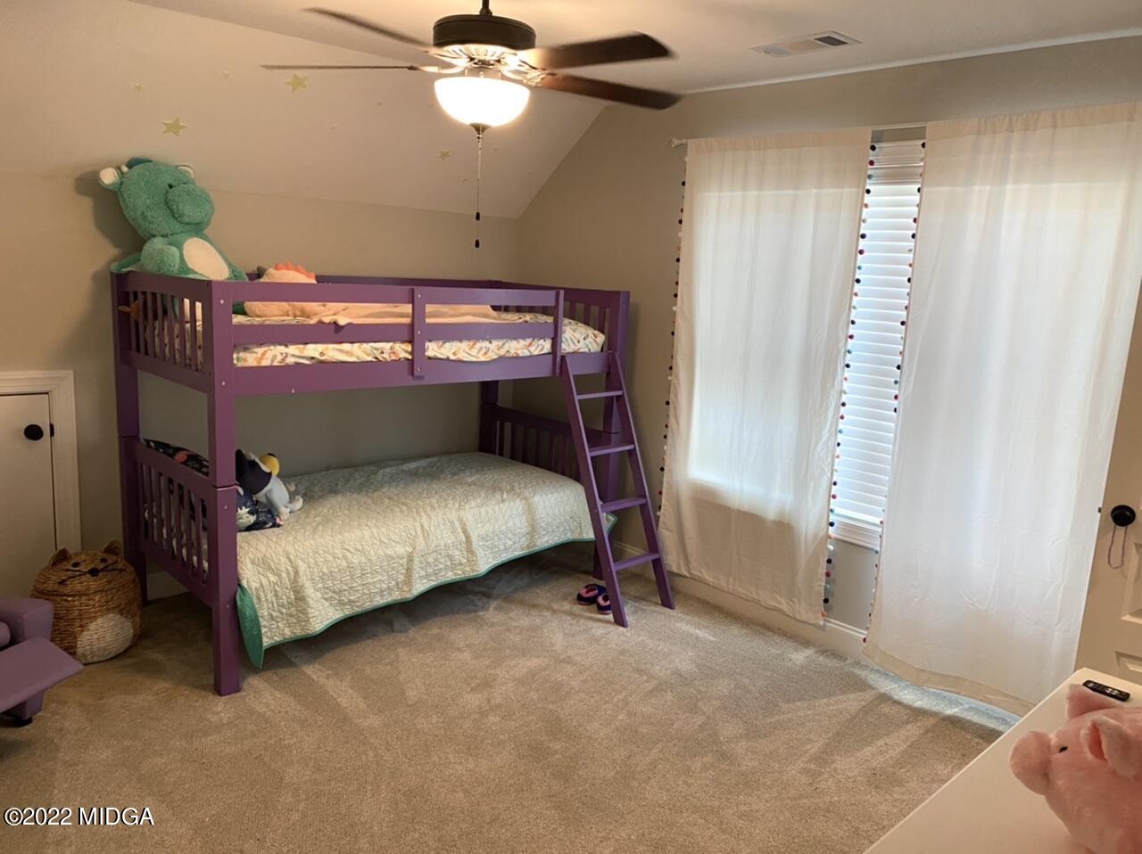 101 Carters Way Forsyth, GA 31029 - Photo 27 of 28 a bedroom with a bed and a window
