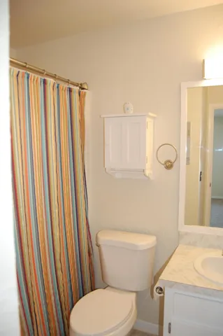 a white toilet sitting next to a bathroom sink