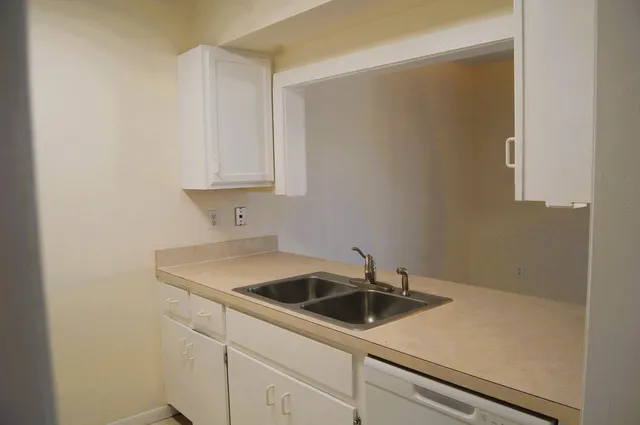 a view of a sink and cabinets