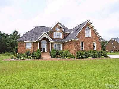 9600 Fanny Brown Road Raleigh, NC 27603 - Photo 1 of 1 a front view of a house with a yard and garage