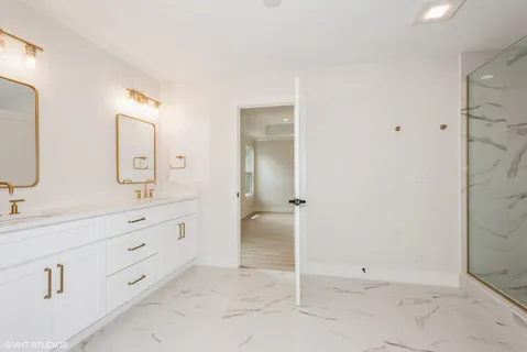 a spacious bathroom with a double vanity sink mirror and double