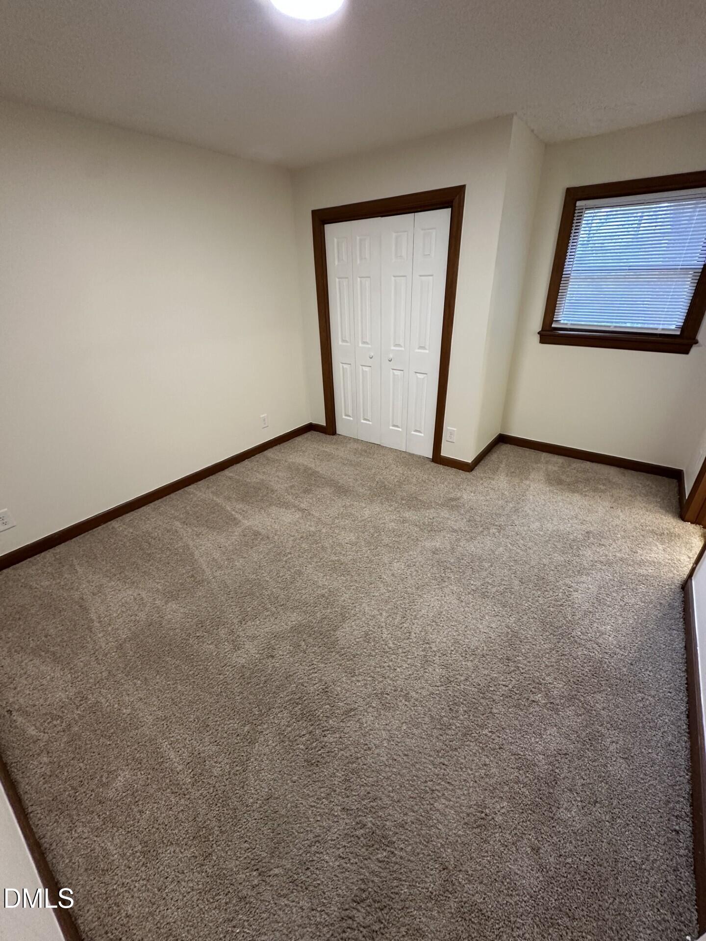 3535 Ivy Commons Drive, Unit 302 Raleigh, NC 27606 - Photo 6 of 9 an empty room with windows and closet