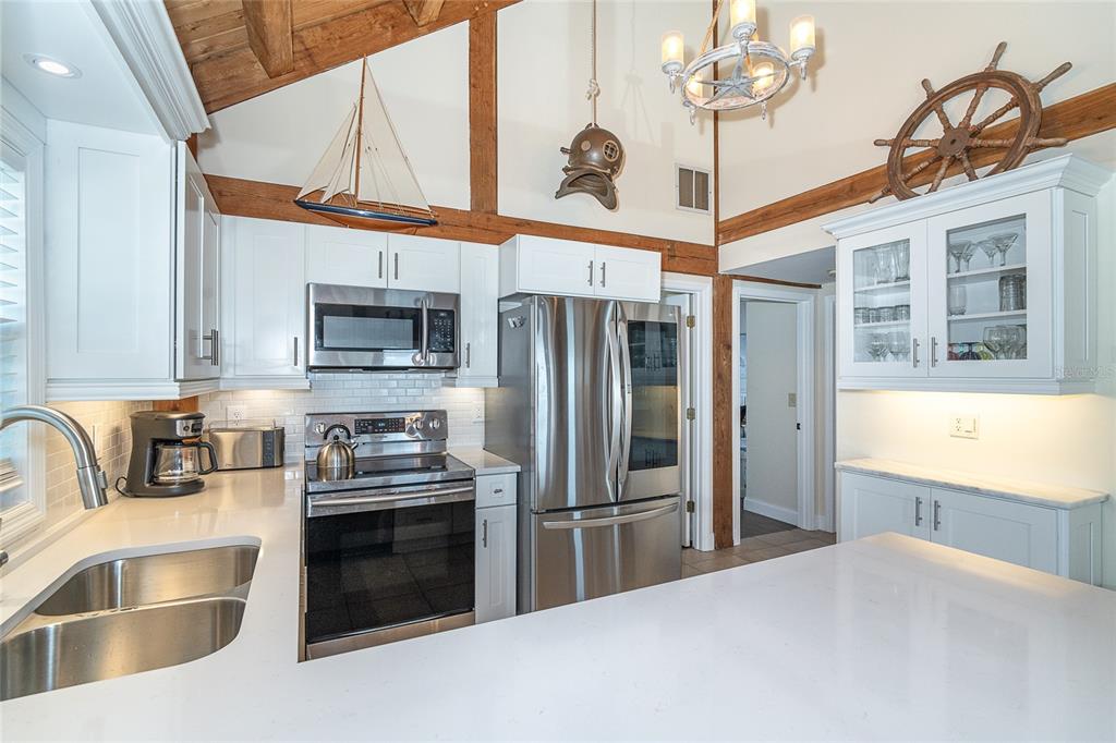 360 South Gulf Boulevard Boca Grande, FL 33921 - Photo 13 of 64 a kitchen with stainless steel appliances granite countertop a sink a stove and a refrigerator