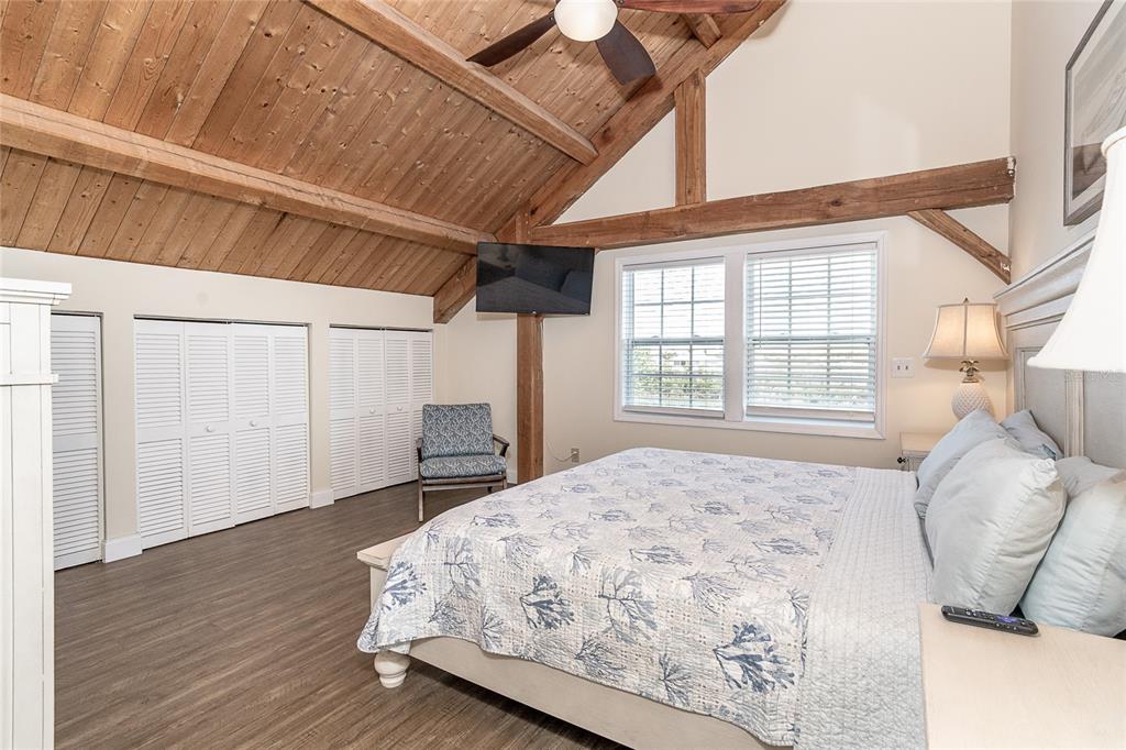 360 South Gulf Boulevard Boca Grande, FL 33921 - Photo 21 of 64 a bedroom with a bed and wooden floor