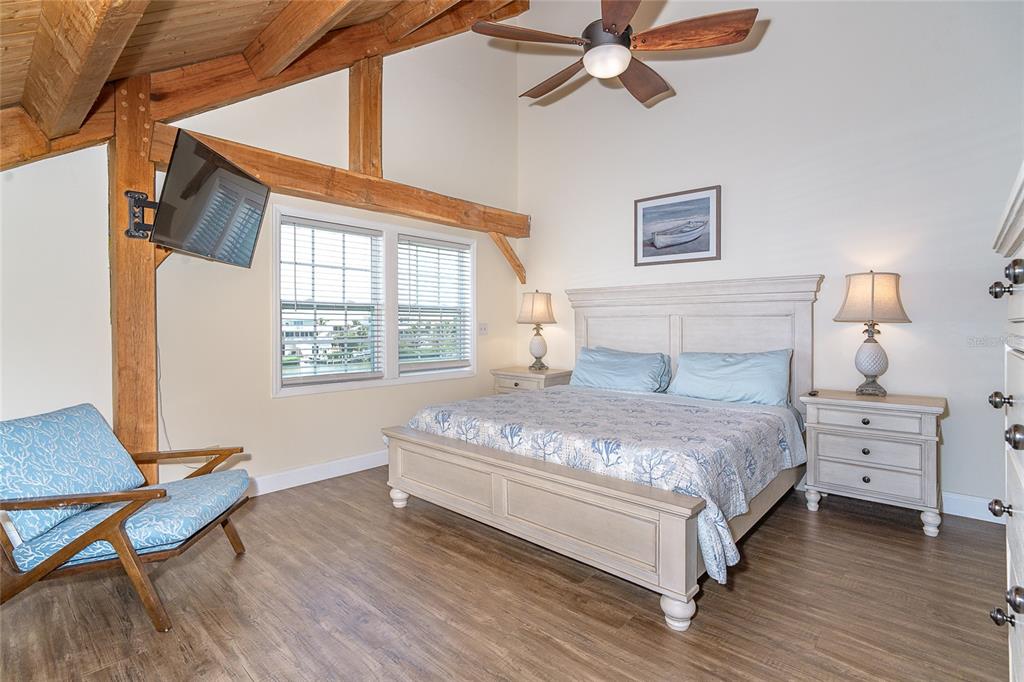 360 South Gulf Boulevard Boca Grande, FL 33921 - Photo 22 of 64 a bedroom with a bed and wooden floor