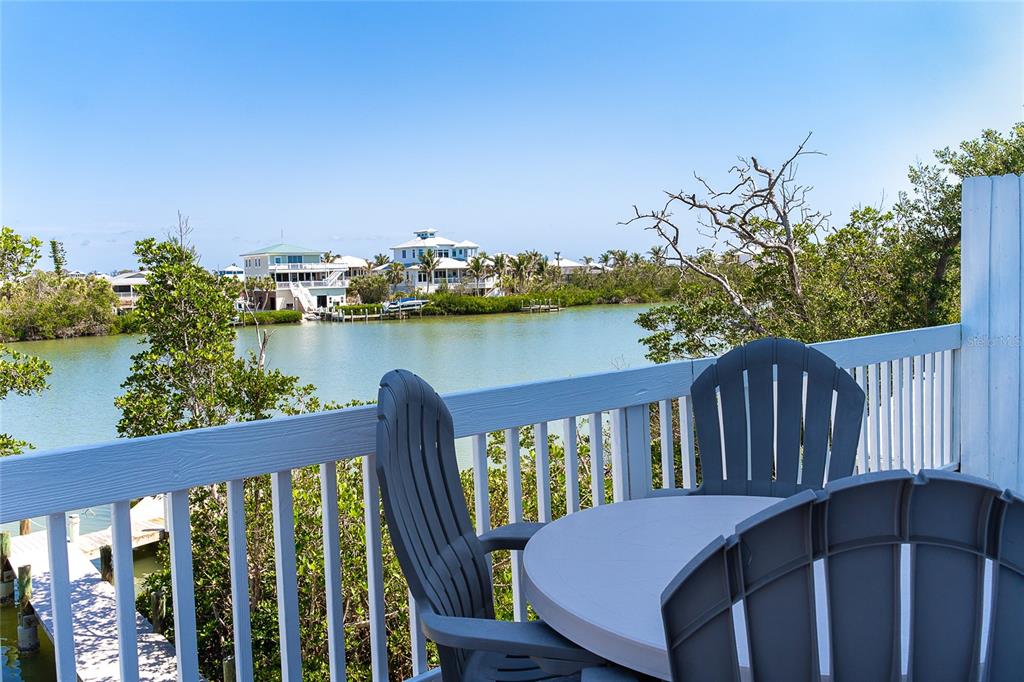 360 South Gulf Boulevard Boca Grande, FL 33921 - Photo 26 of 64 a view of a deck with two chair and wooden floor