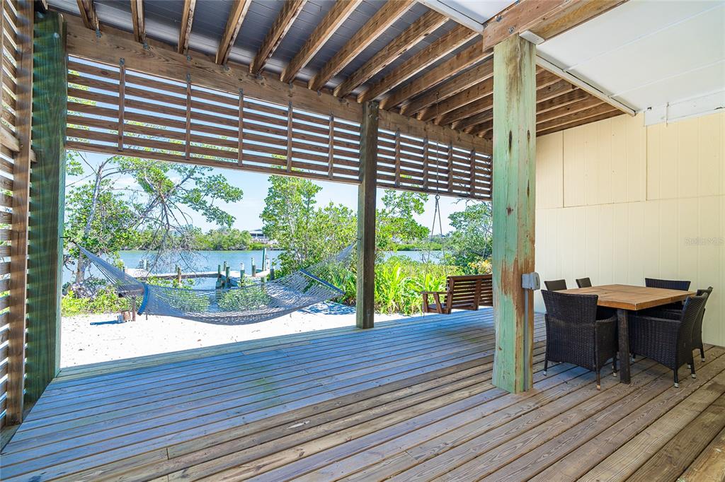 360 South Gulf Boulevard Boca Grande, FL 33921 - Photo 32 of 64 a view of a deck with wooden floor and outdoor seating