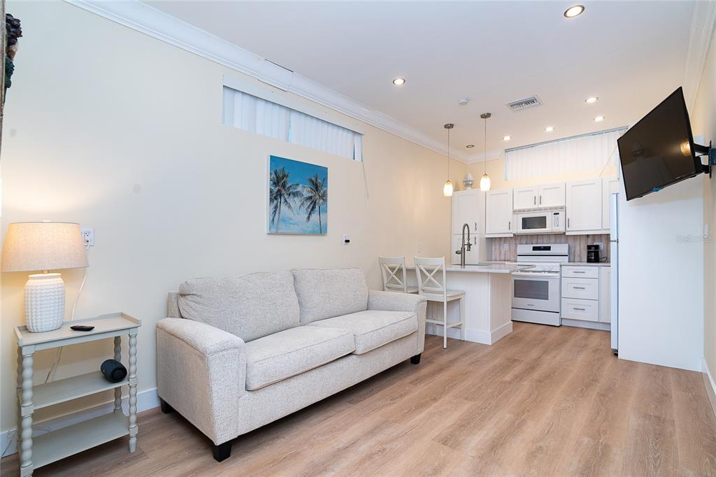 360 South Gulf Boulevard Boca Grande, FL 33921 - Photo 39 of 64 a living room with stainless steel appliances kitchen island furniture and a flat screen tv