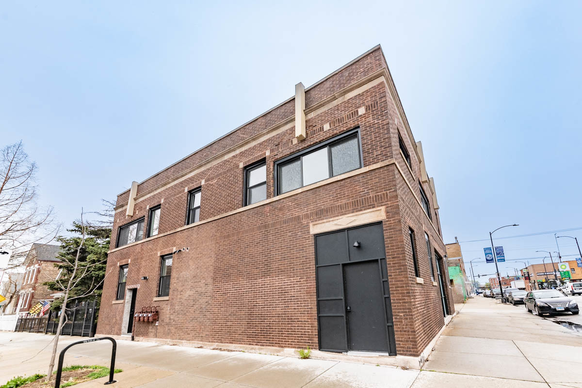 a front view of a building with parking