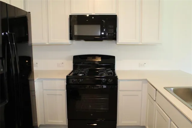 a kitchen with a stove and a microwave