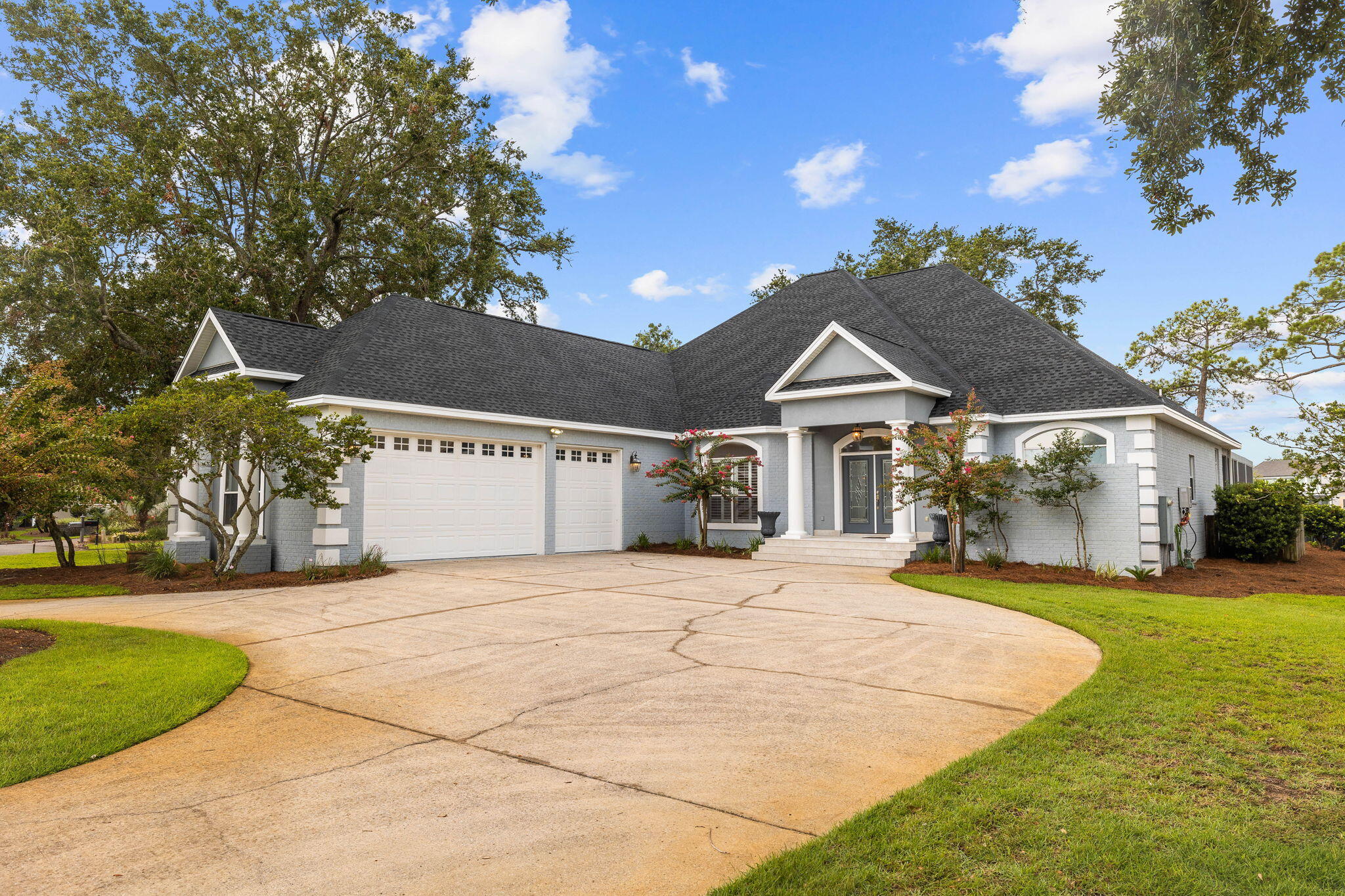 1780 Driftwood Point Road Santa Rosa Beach, FL 32459 - Photo 11 of 101 a front view of a house with a yard and garage