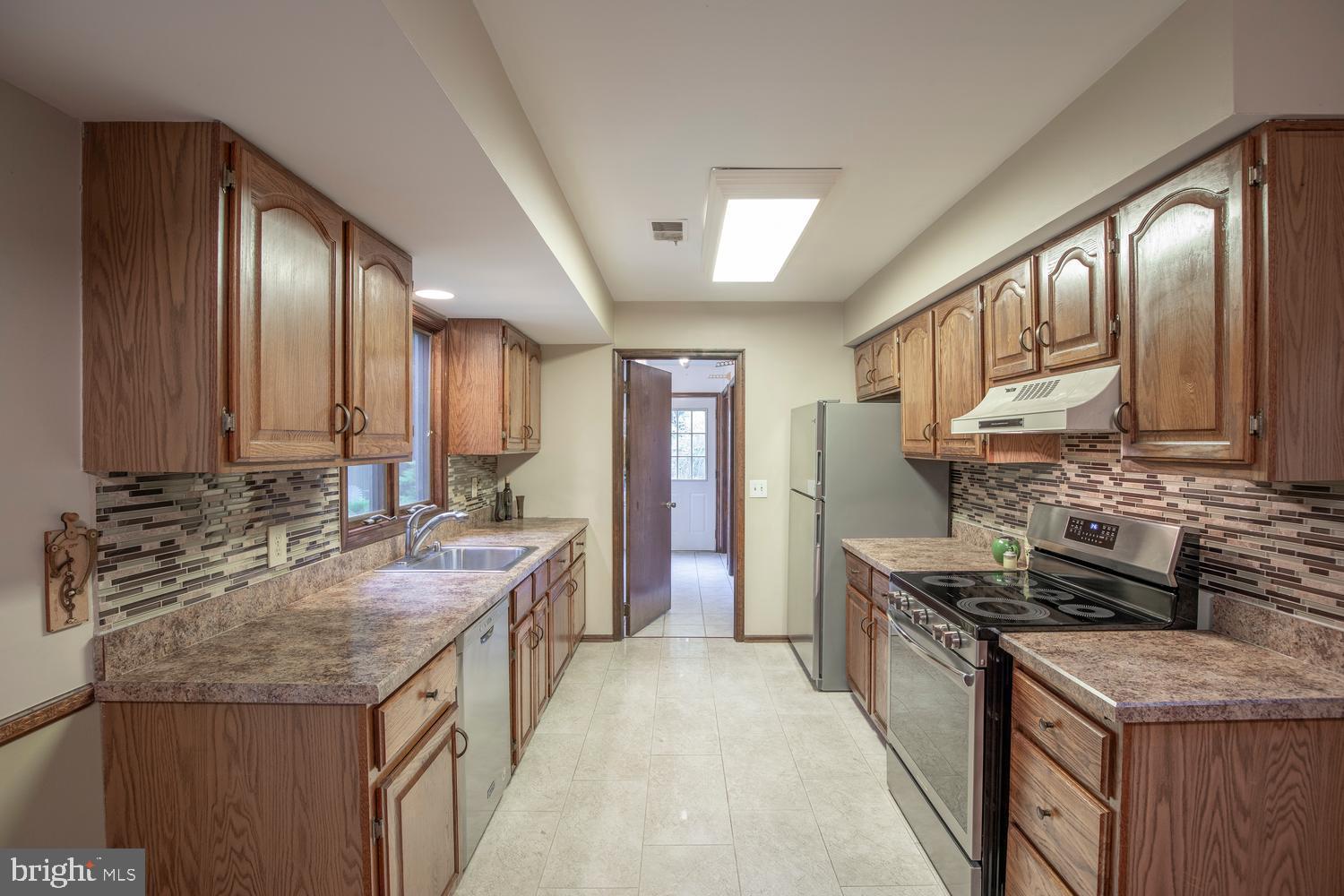 225 Pueblo Road Doylestown, PA 18901 - Photo 13 of 35 a kitchen with stainless steel appliances granite countertop a sink stove and cabinets
