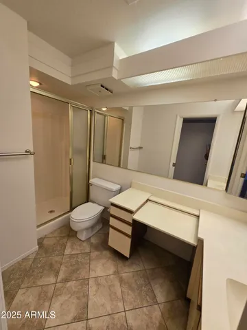 a bathroom with a toilet sink and shower