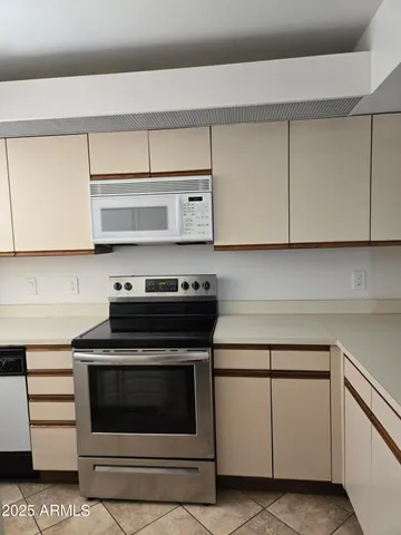 a stove top oven sitting inside of a kitchen