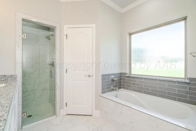 a bathroom with a bathtub and shower
