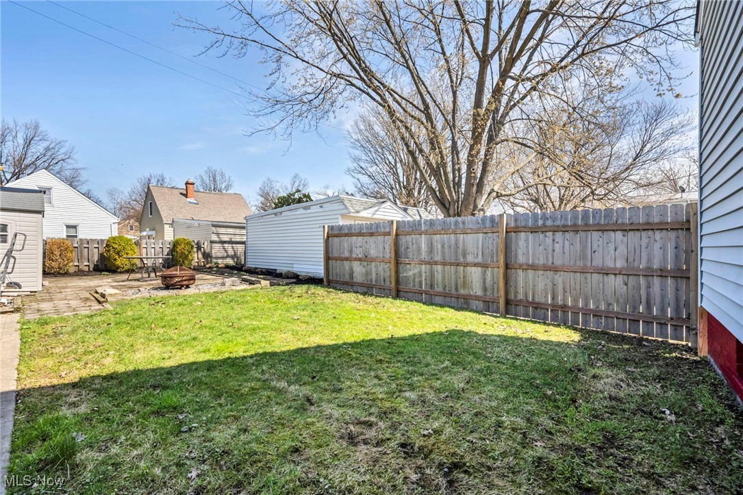 23761 Colbourne Road Euclid, OH 44123 - Photo 19 of 21 View of yard featuring a fenced backyard and a fire pit