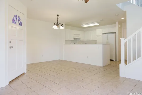 a view of a kitchen with a refrigerator cabinets and a wooden floor