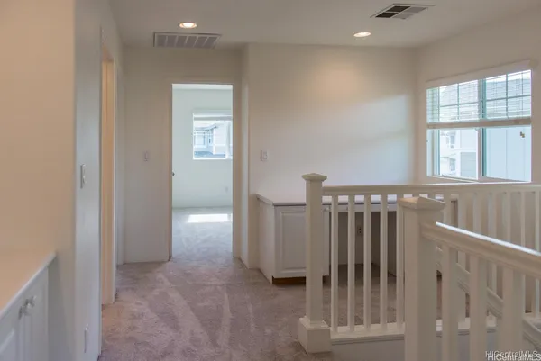 a view of a hallway with windows