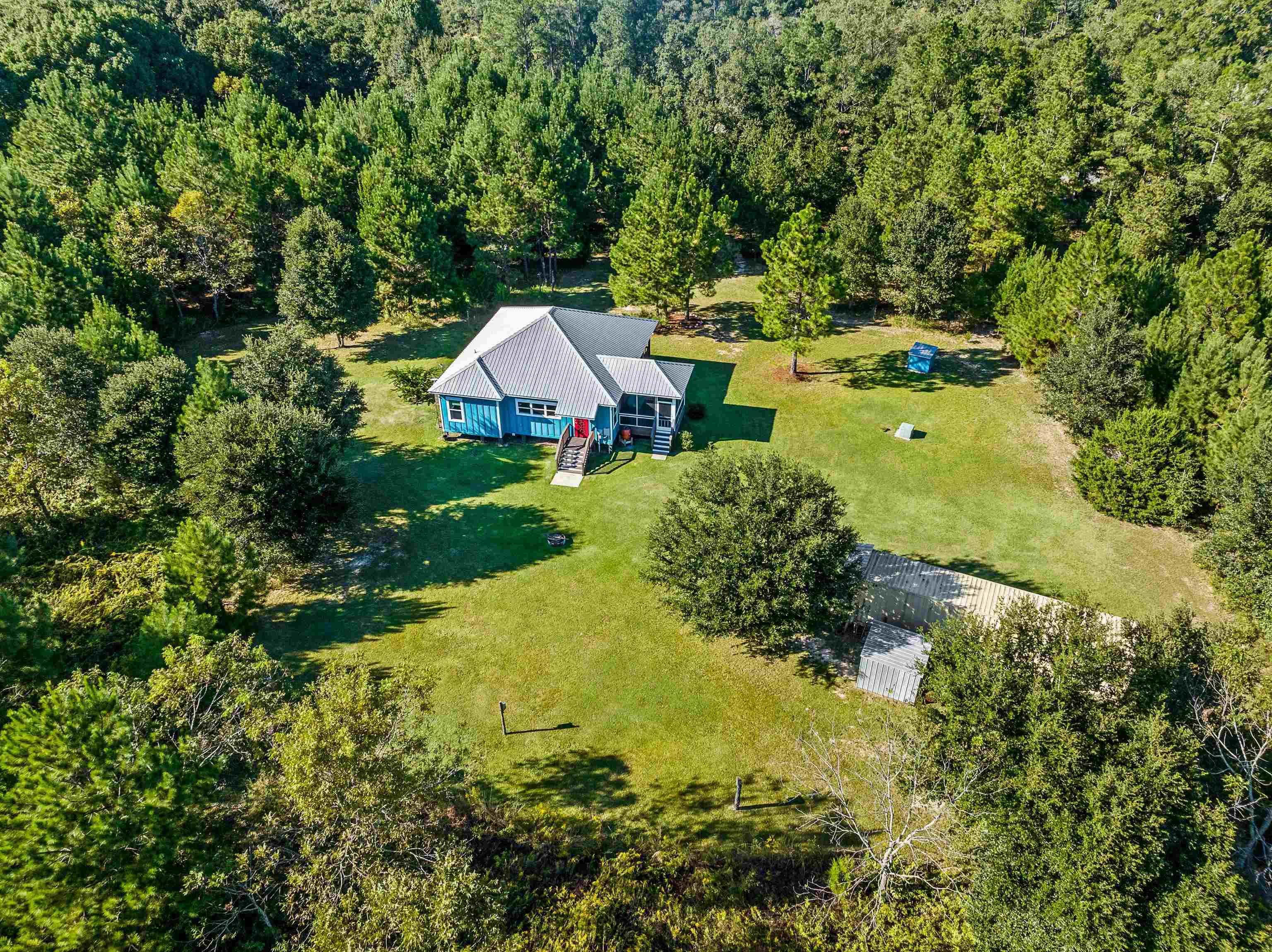 24616 Bretz Lane Elberta, AL 36530 - Photo 7 of 42 Drone view of property setting among mature trees and open space.