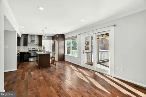 a view of kitchen with sink and refrigerator