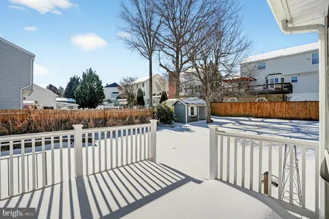 a view of a house with a wooden fence