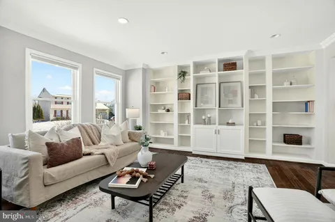 a living room with furniture and view of kitchen