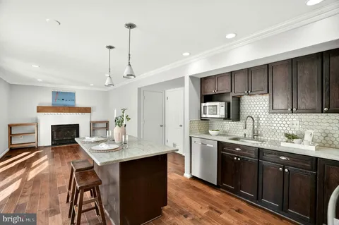 a kitchen with granite countertop a sink stove and refrigerator