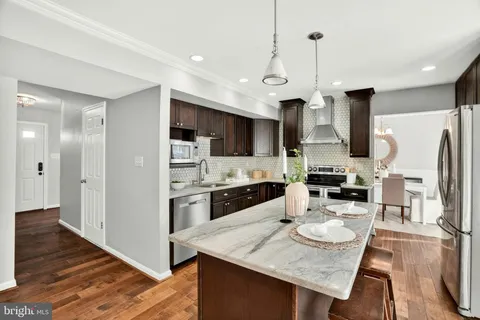 a kitchen with stainless steel appliances granite countertop a sink refrigerator and microwave