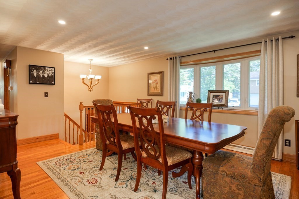 14 Princeton Road Burlington, MA 01803 - Photo 13 of 40 a view of a dining room and livingroom with furniture wooden floor a rug and a chandelier