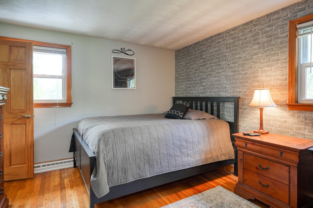 14 Princeton Road Burlington, MA 01803 - Photo 15 of 40 a bedroom with a bed and wooden floor